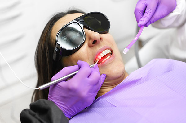 woman getting treatment with dental laser
