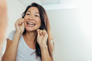 woman flossing her teeth